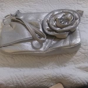 Silver with a golden hue evening wristlet/clutch ornate flower deco same color